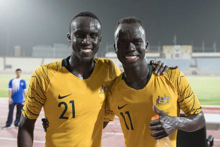 Socceroos players Thomas Deng and Awer Mabil after beating Kuwait.