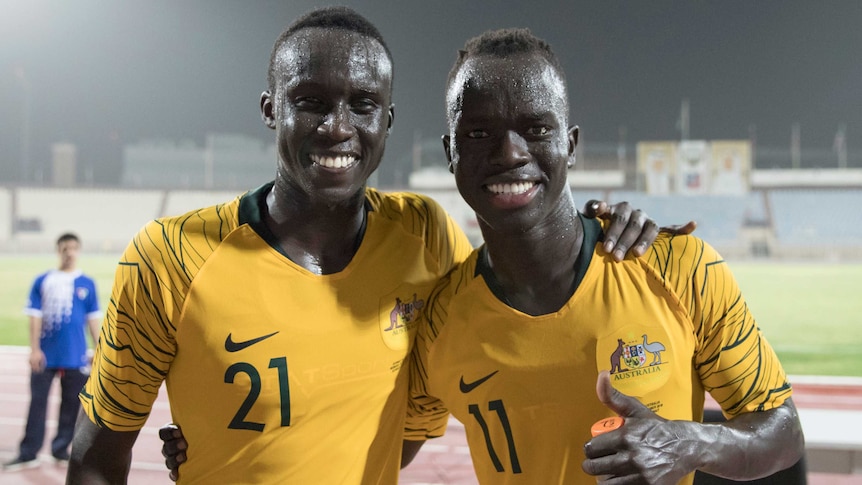 Socceroos players Thomas Deng and Awer Mabil after beating Kuwait.