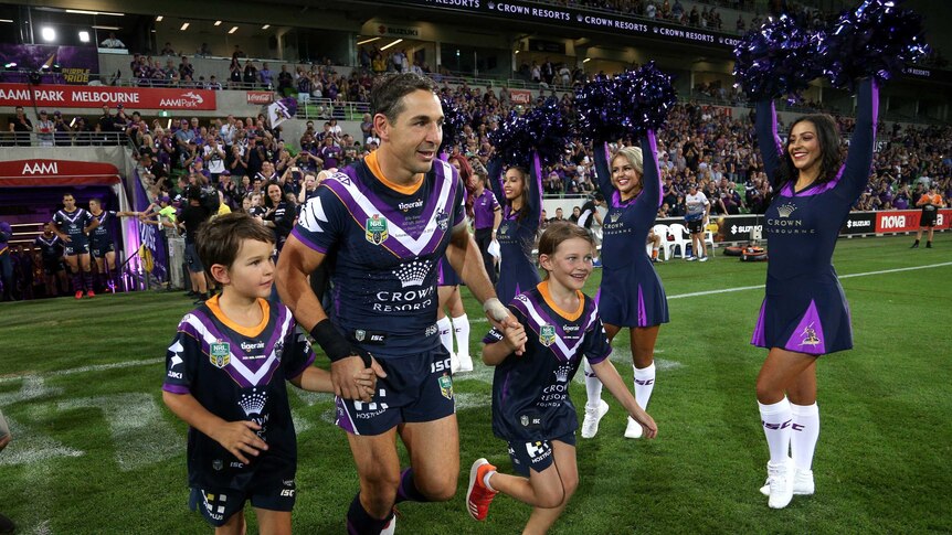 Billy Slater on the field with his children during his 300th NRL match