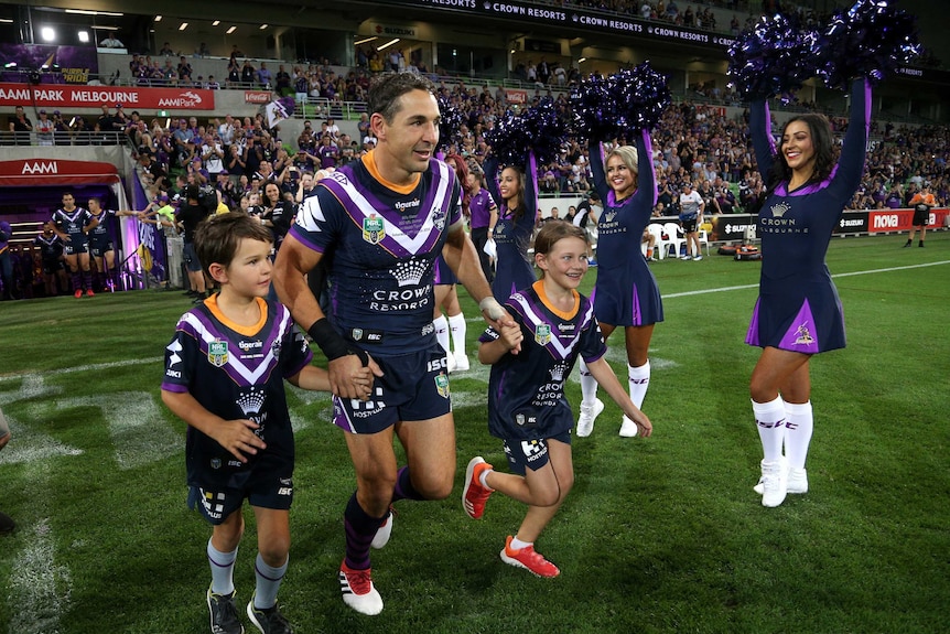 Billy Slater on the field with his children during his 300th NRL match