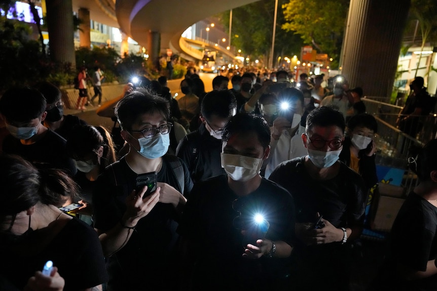 People light LED candles to mark the anniversary of the military crackdown