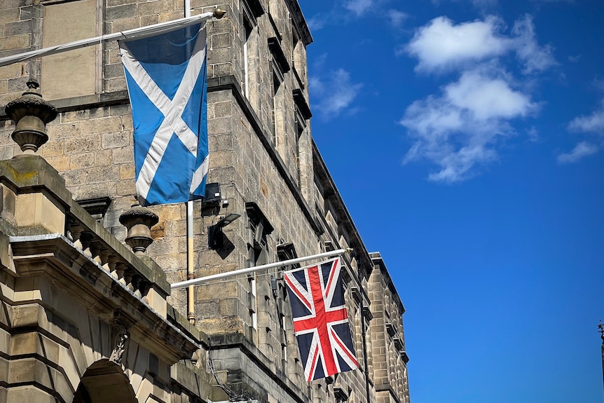 Union Jack and Scottish flag hanging over Edinburgh's royal mile.
