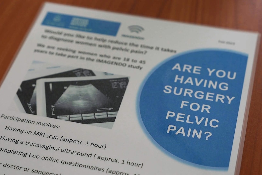 A laminated A4 piece of paper with the words 'Are you having surgery for pelvic pain' printed on it among other details