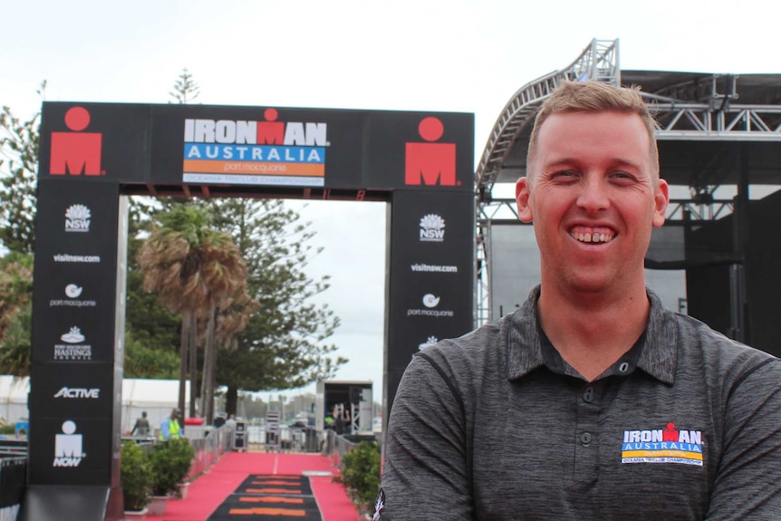 A man at the finish line of Ironman Australia.