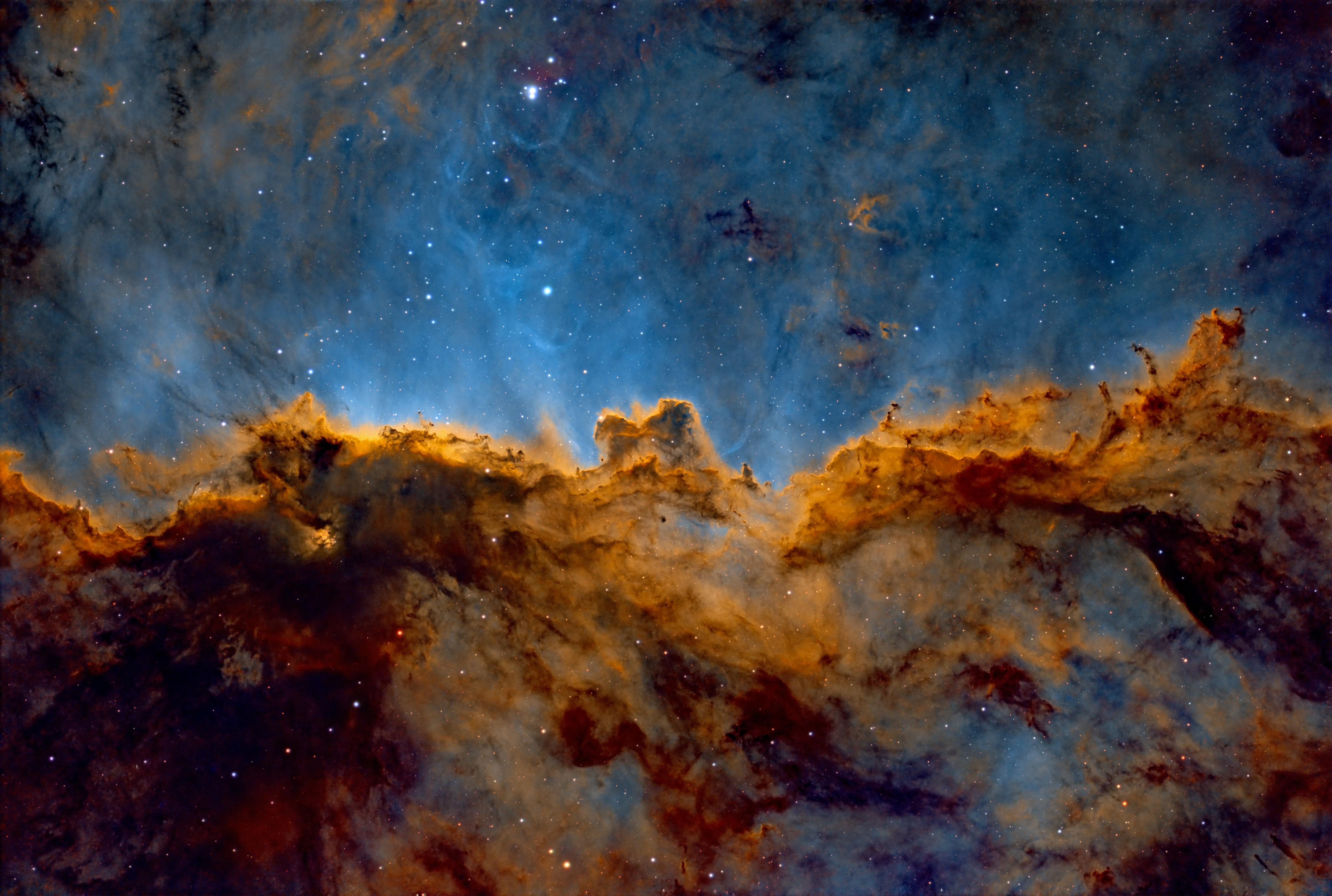 A brown nebula with streaks of blue light behind.