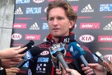 Essendon coach James Hird speaks to the media at training.
