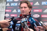 Essendon coach James Hird speaks to the media at training.