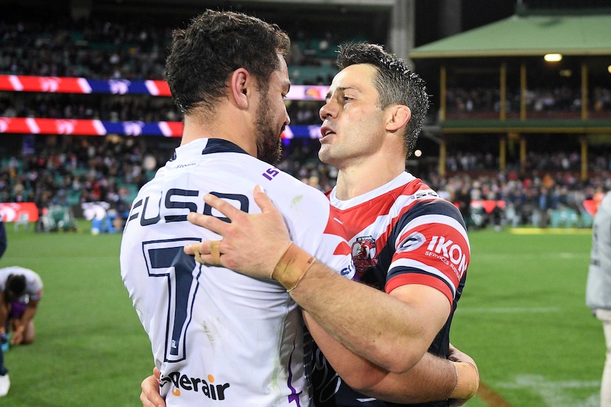 Melbourne Storm halfback Jahrome Hughes hugs Sydney Roosters halfback Cooper Cronk after the 2019 NRL preliminary final.