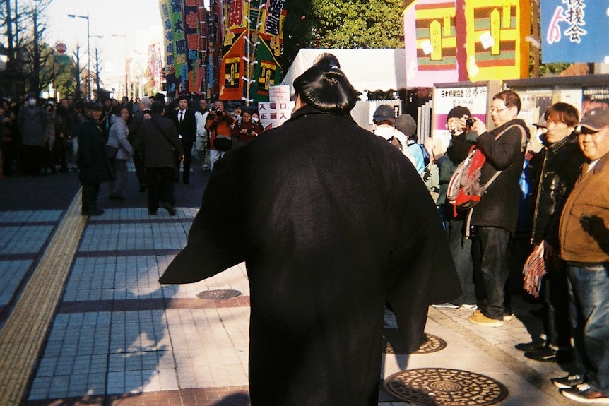 A Japanese sumo wrestler makes his way to a Tokyo stadium to compete