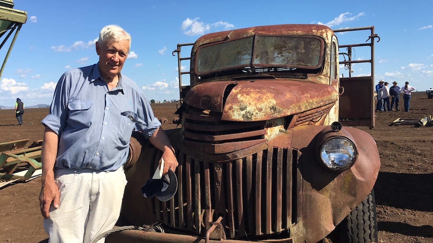 Tony Elliott stands next to an old truck.