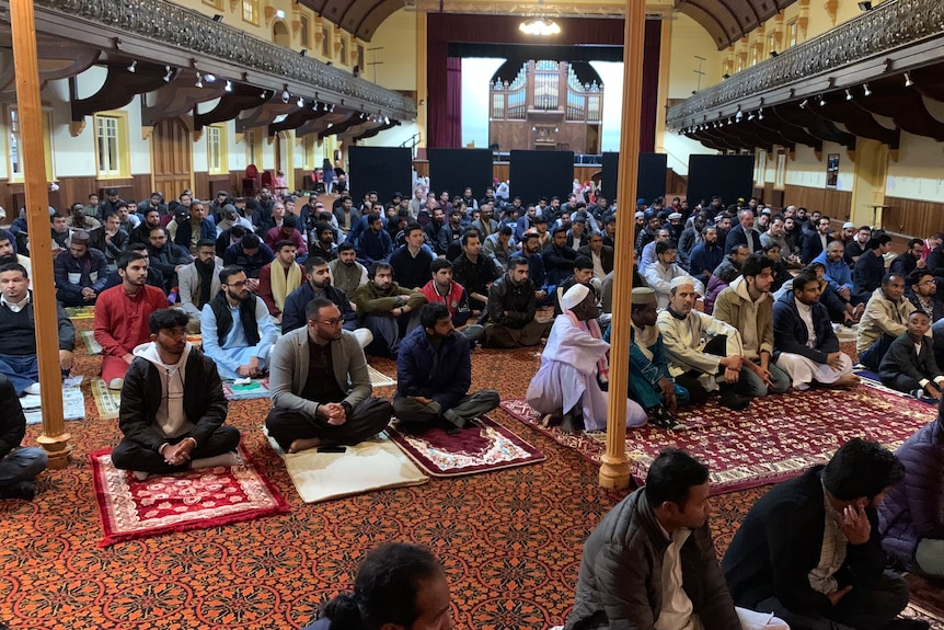 Muslim people in Tasmania sitting on the Albert Hall. 