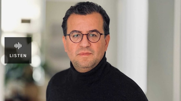 A man with black hair and glasses. Has Audio.