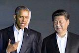 Barack Obama and Xi Jinping walk outside White House