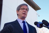 Upshot of WA Treasurer Mike Nahan with media microphones.