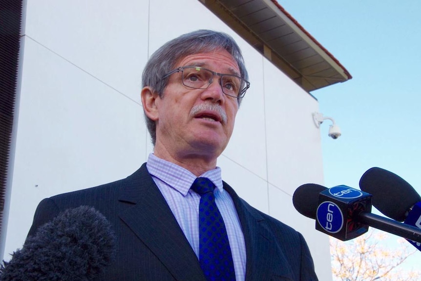 Upshot of WA Treasurer Mike Nahan with media microphones.