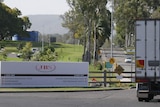 A truck entering a meat processing plant.