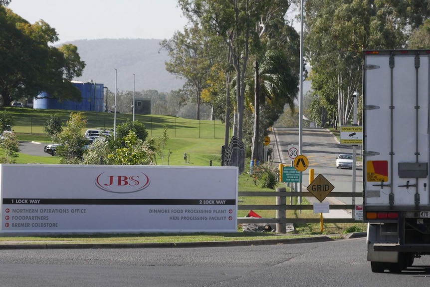 A truck entering a meat processing plant.