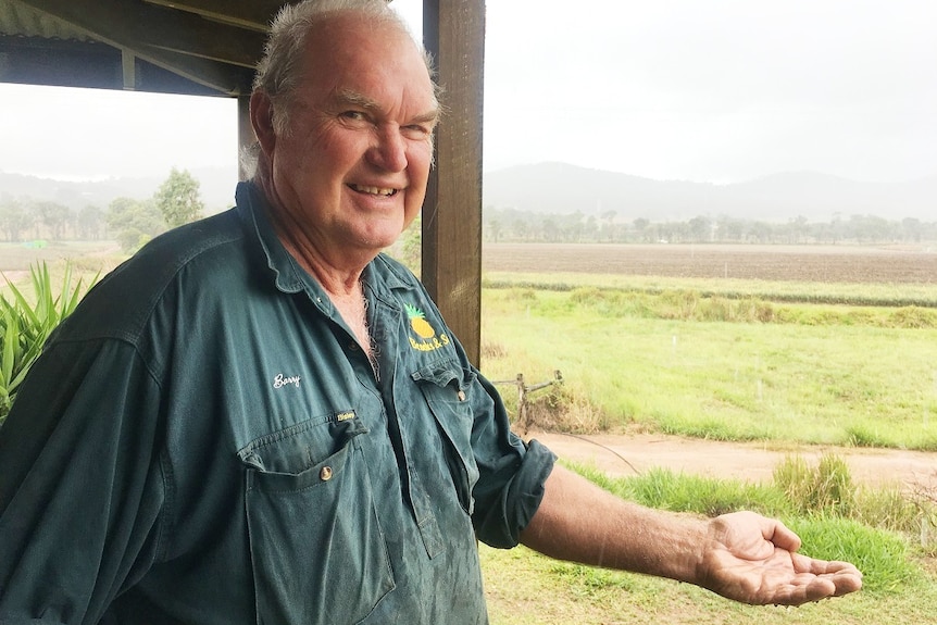 Barry Brooks puts his hand out to feel the rain