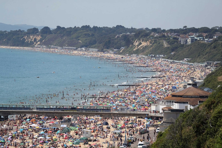 View from above of a crowded English beach.