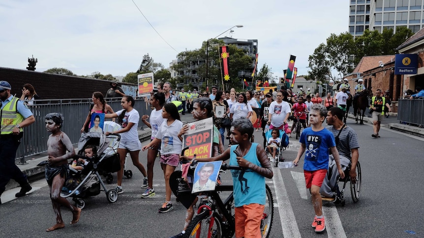 Protesters march through the streets of Redfern to remember the death of 'TJ' Hickey.