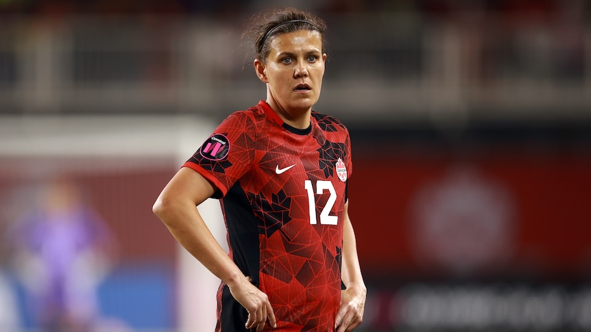 A woman in a red soccer jersey.