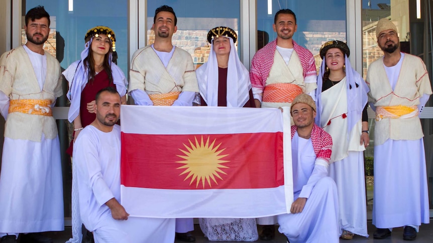 The Toowoomba Ezidi dance group pose for a photo at the Regional Settlement Conference.