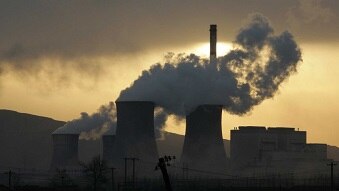 A coal-fired power plant surrounded by smog and smoke