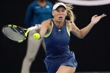 Caroline Wozniacki hits a forehand return to Simona Halep in the women's Australian Open final.