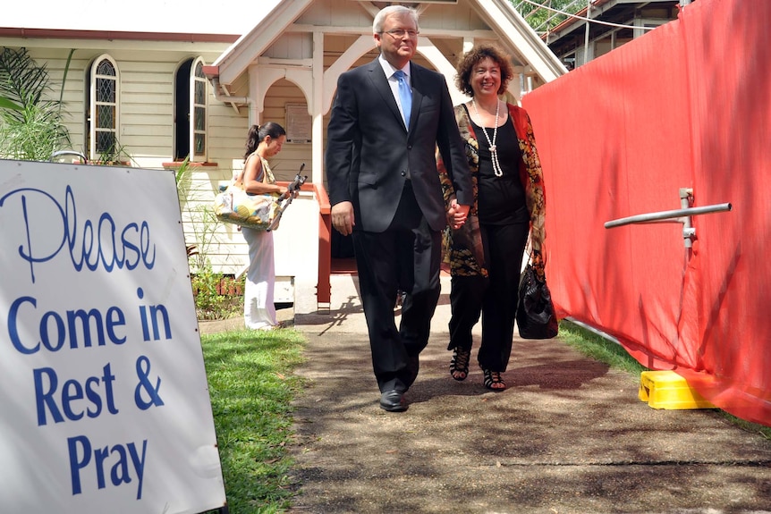 Kevin Rudd leaves a Brisbane church service with wife Therese Rein
