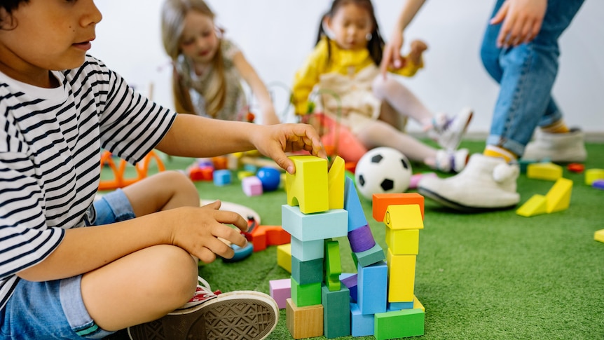 Boy with building blocks at daycare.