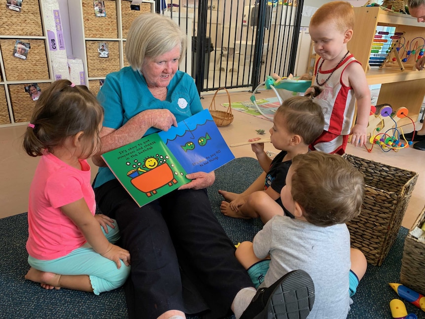 Gail Farrawell, 65, reads a book to children at a childcare centre.