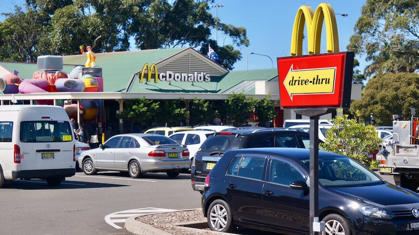 Cars in a car park of fast food restaurant McDonalds.