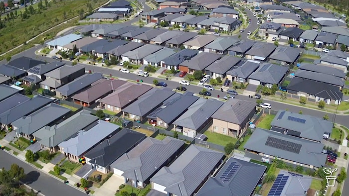 Aerial view of unshaded rooftops in new urban housing estate