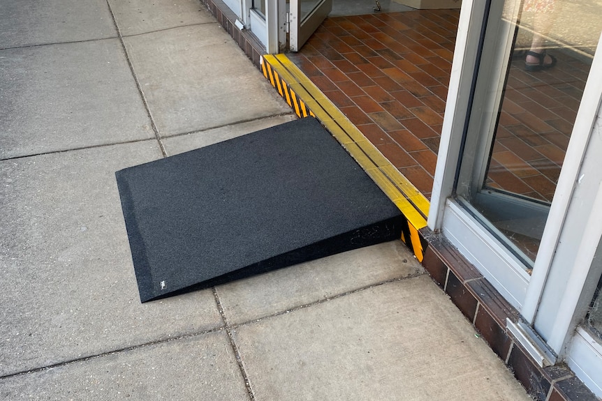 A black ramp against a building entry.