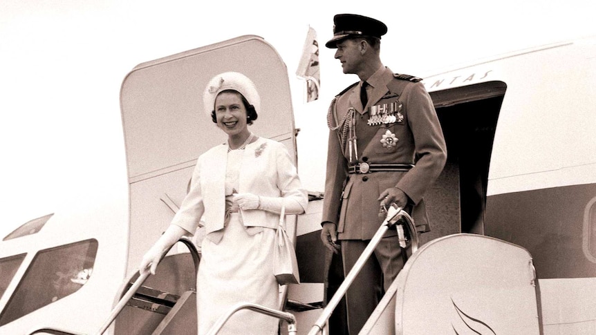 The Queen and Duke of Edinburgh dismount from a plane.