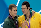 Silver medallist Christian Sprenger (R) congratulates South Africa's Cameron van der Burgh.