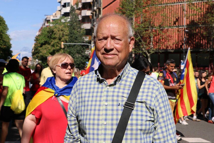 An older man in a crow of protestors'