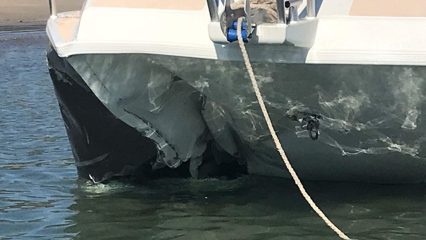 Close-up of damaged to boat found drifting by Yeppoon Water Police with two men dead onboard.