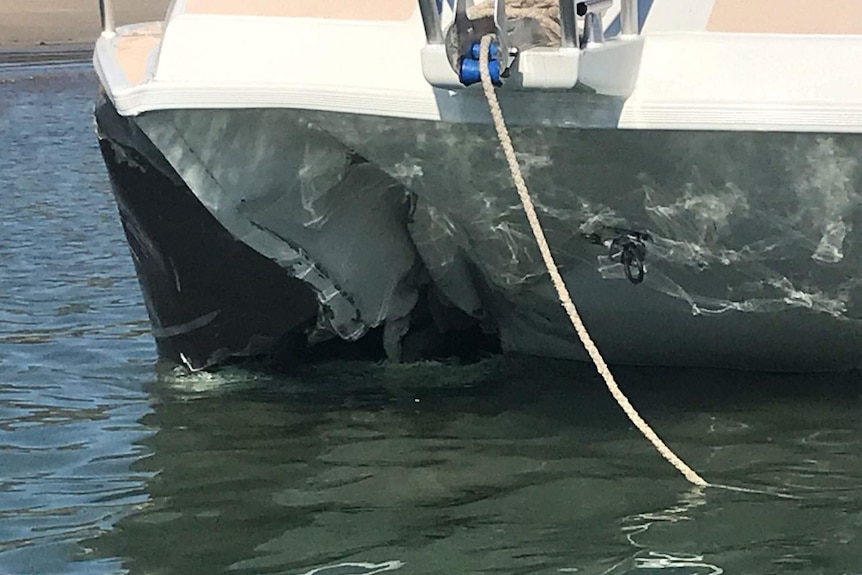 Close-up of damaged to boat found drifting by Yeppoon Water Police with two men dead onboard.