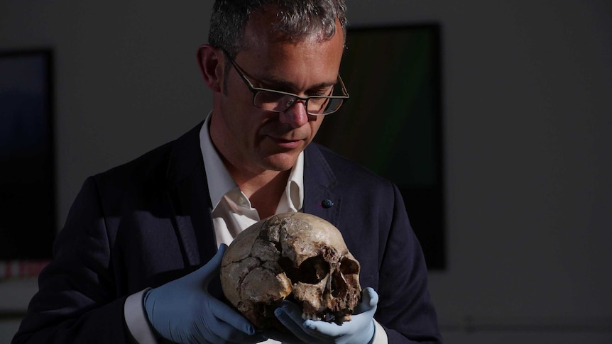 Professor Ian Barnes displays the skull of cheddar man