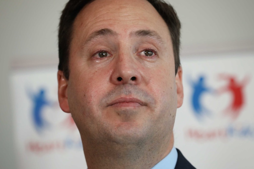 A close-up on Steve Ciobo's face shows a tear rolling down his cheek.