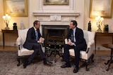 David Cameron speaks with European Council President Donald Tusk.