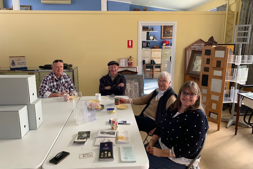 four adults sitting around a table. 