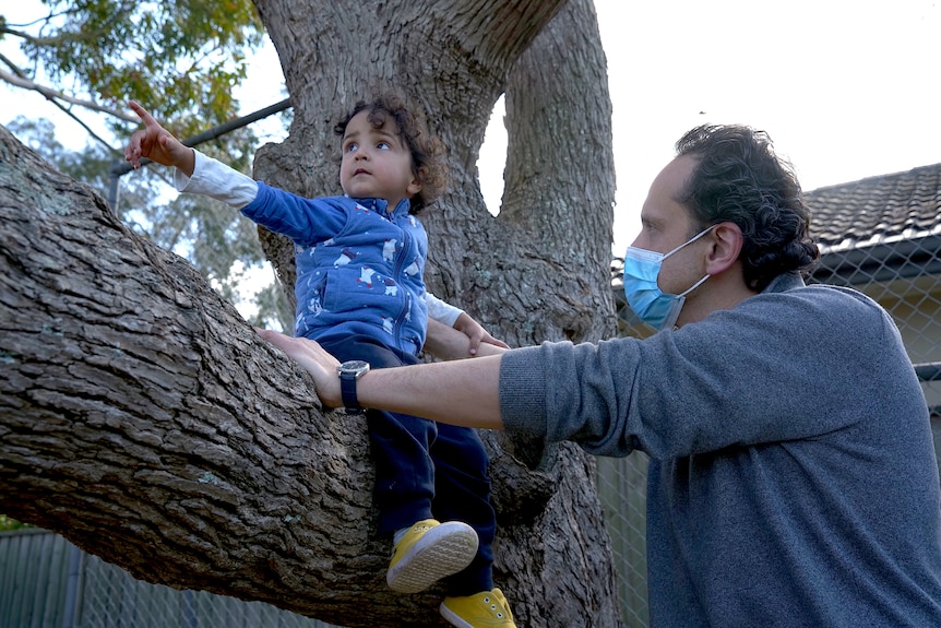 Two-year-old Elijah Basman Reimi climbs a tree
