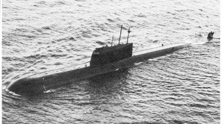 A black-and-white image of a submarine in the water.