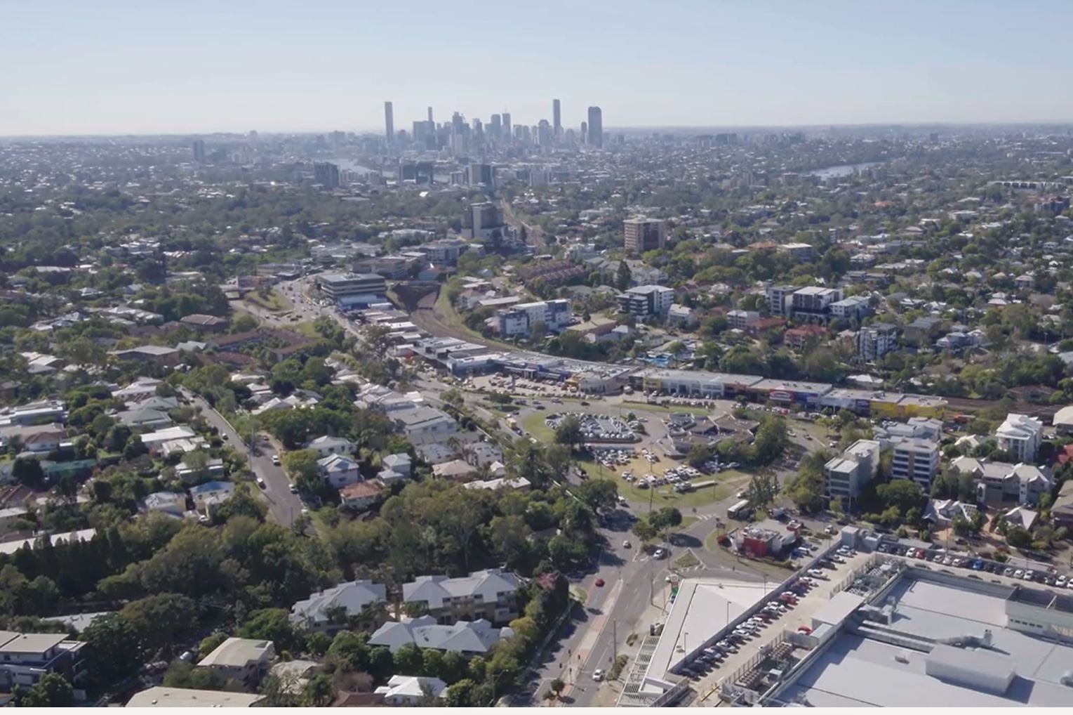 A drone video of a large roundabout with a car sales yard in the centre