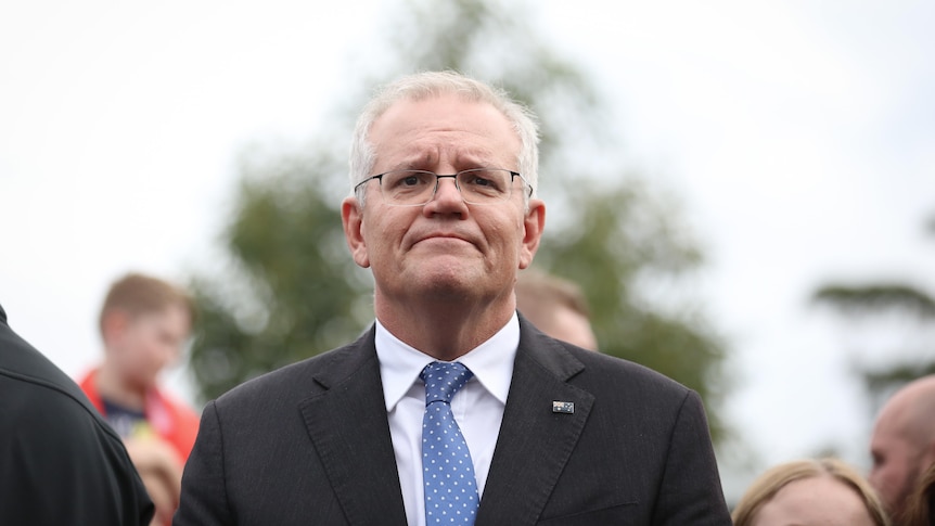 Scott Morrison looks straight at the camera, looking downcast 