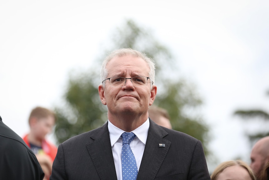 Scott Morrison looks straight at the camera, looking downcast 