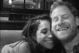 A black and white photo of Harry and Meghan embracing