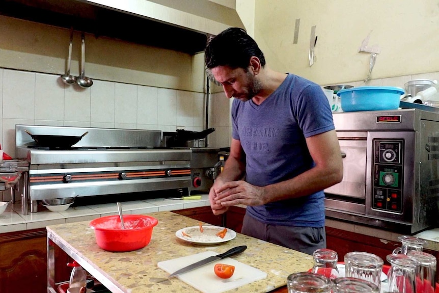 Abdullah Zalghani making hummus in his restaurant